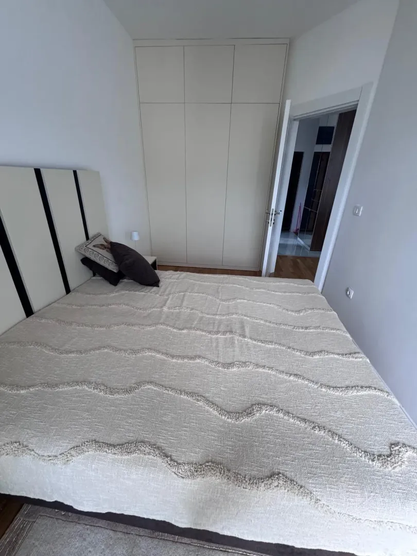 Spavaća soba sa bračnim krevetom i ugradnim plakarom.