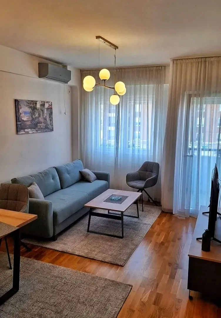 Living room with a sofa, coffee table, and dining table.