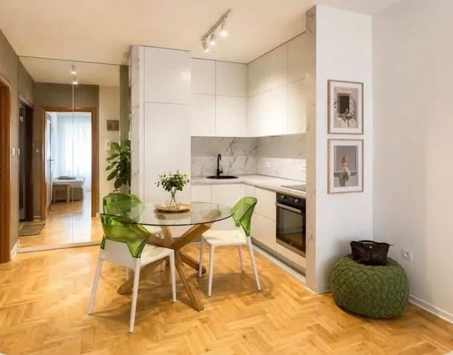 Modern kitchen with dining area and built-in appliances.
