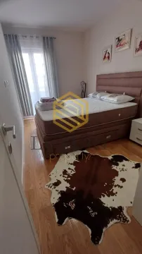 Bedroom with a double bed, hardwood flooring, and a decorative rug. - image 6