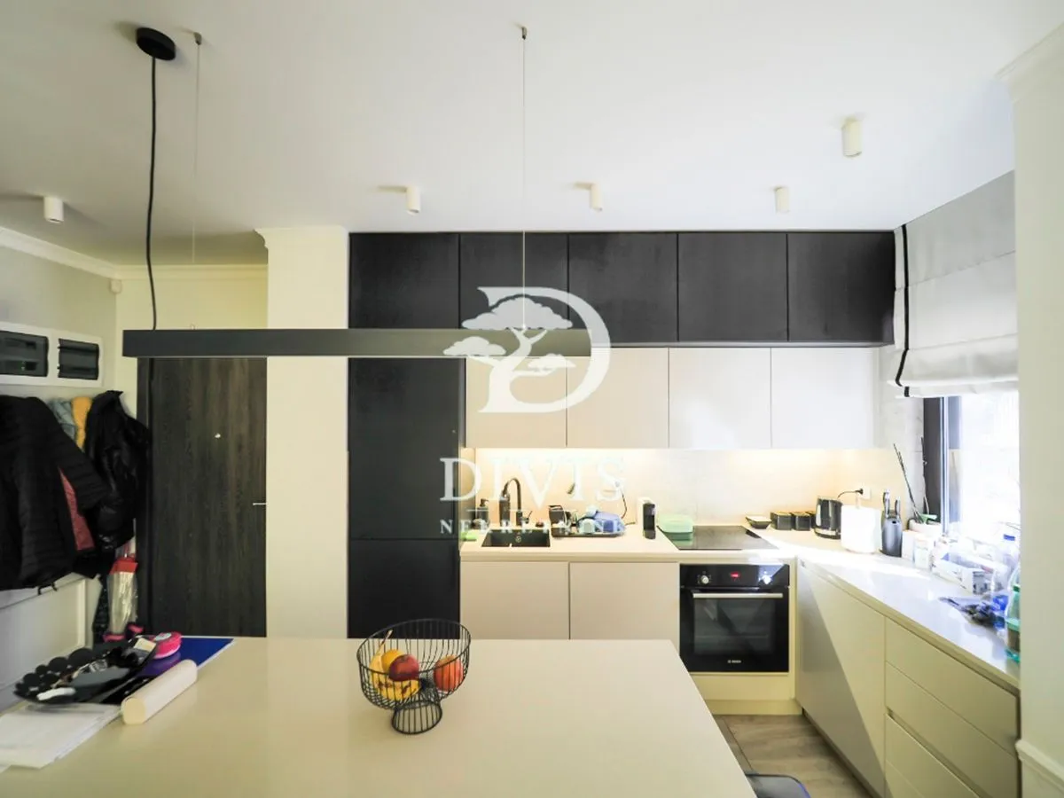 Modern kitchen with built-in appliances and a dining island.