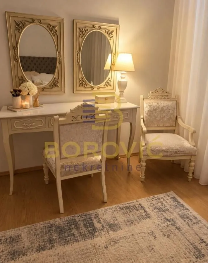 Bedroom with a stylish vanity table and mirrors.