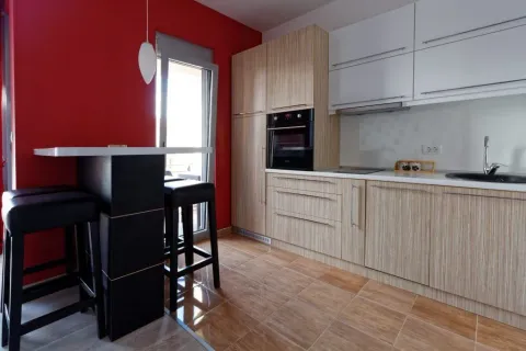 Modern kitchen with wooden cabinets, a breakfast bar, and access to the terrace. - image 6