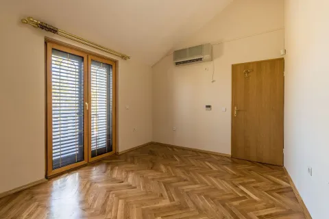 An empty room featuring wooden parquet flooring, an air conditioning unit, and balcony doors. - image 7