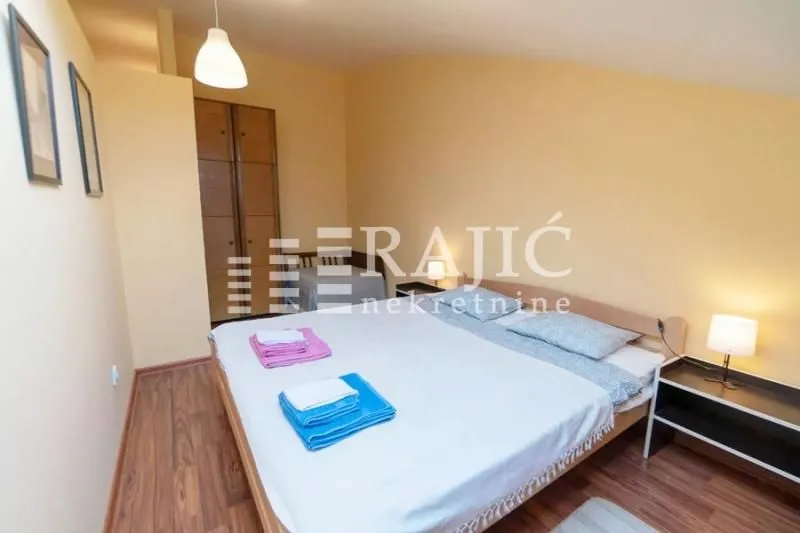 Bedroom with a double bed, wardrobe, and sloped ceiling.