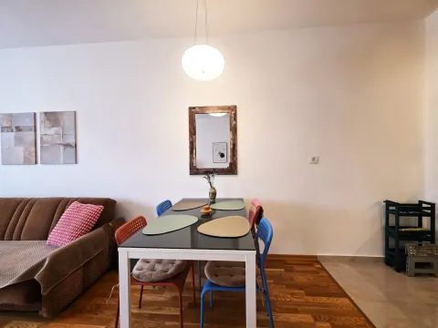 Living room with a dining table and chairs. - image 5