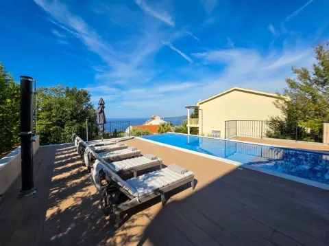 Terrace with a swimming pool and sun loungers overlooking the sea. - image 9