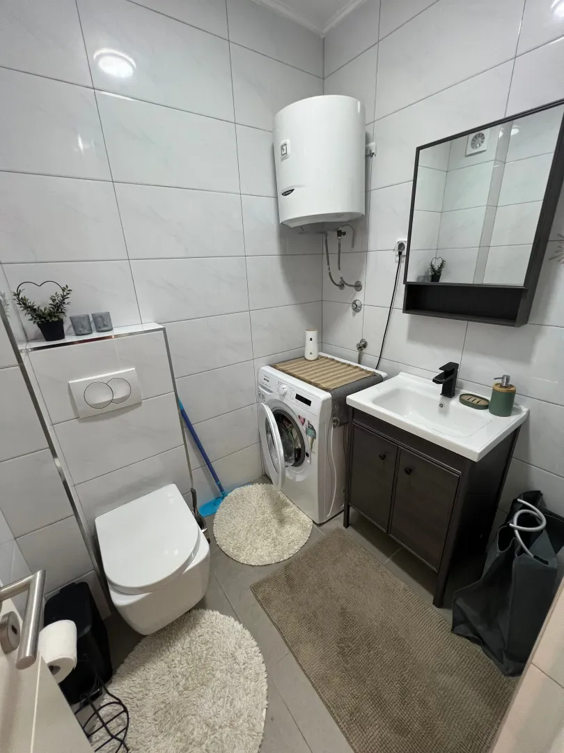 Manje kupatilo sa tuš kabinom, umivaonikom i wc šoljom.