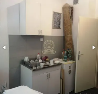 Small kitchen with a sink, cabinetry, and a refrigerator. - image 13