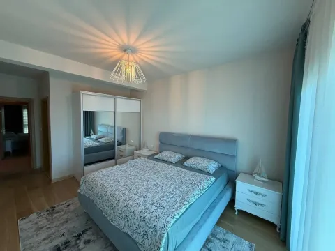 Furnished bedroom with a double bed, wardrobe, and nightstands. - image 7
