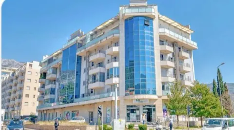 Exterior of a multi-family residential building with glass facade elements and balconies. - image 4