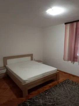 Simply furnished bedroom with a double bed and nightstands. - image 4