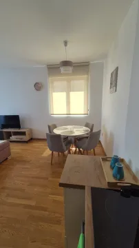 Living room with a dining table and window. - image 17