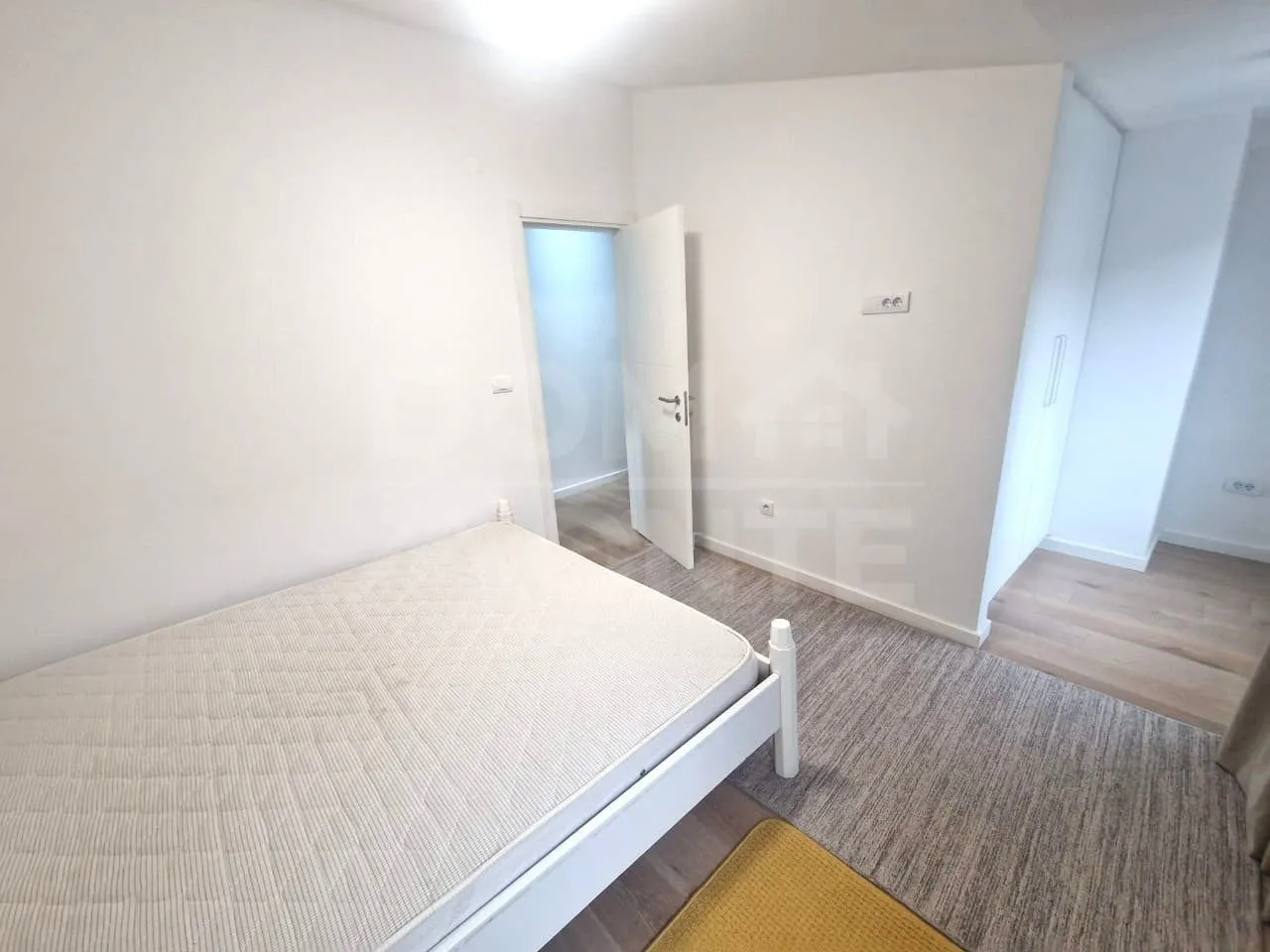 Bright bedroom with a bed and a fitted wardrobe.