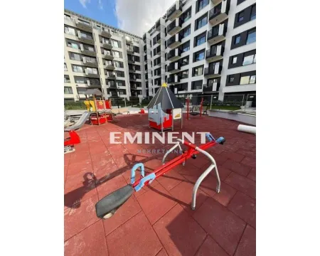 Children's playground with equipment in front of a modern residential building. - image 15