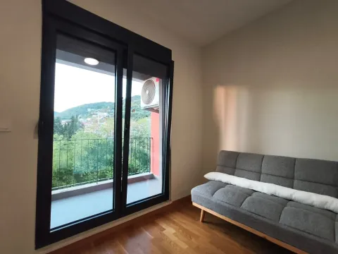 Living room with a grey sofa and access to the terrace. - image 12
