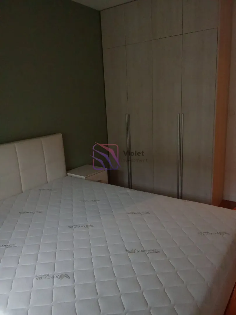 Bedroom with a double bed and a fitted wardrobe.