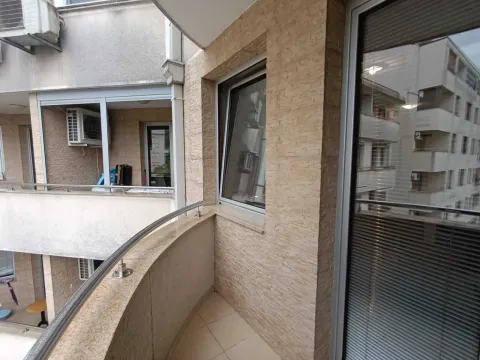 Small tiled balcony with stainless steel railing and stone-clad wall. - image 16
