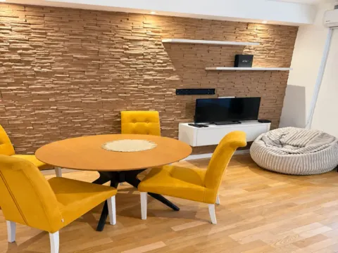Living room with a dining table and yellow chairs. - image 2