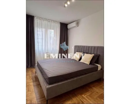 Bedroom with a double bed, parquet flooring, and a window with dark curtains. - image 7