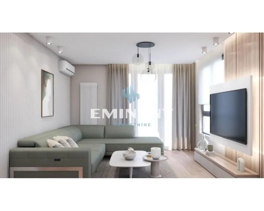 Living room with a sectional sofa, coffee table, and wall-mounted TV.