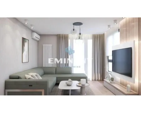Living room with a sectional sofa, coffee table, and wall-mounted TV. - image 4