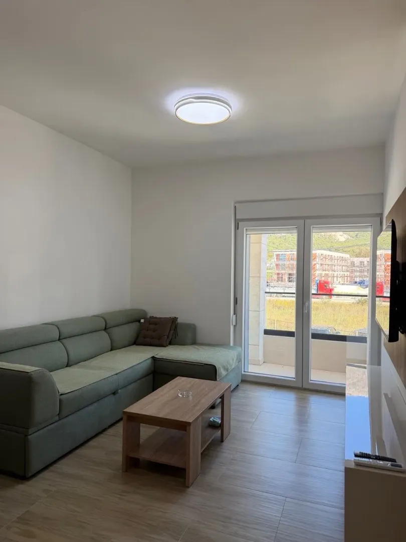 Living room with a sofa and access to the terrace.