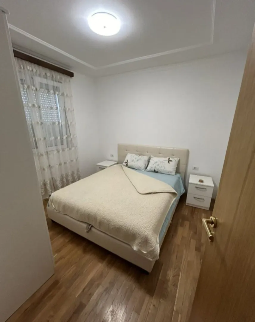 Furnished bedroom with a double bed and nightstands.