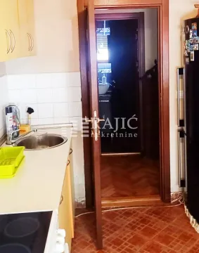 Small kitchen with a sink and a view towards the hallway. - image 3