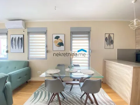 Living room with dining area and sofa. - image 2
