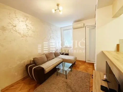 Living room with a sectional sofa and parquet flooring. - image 2