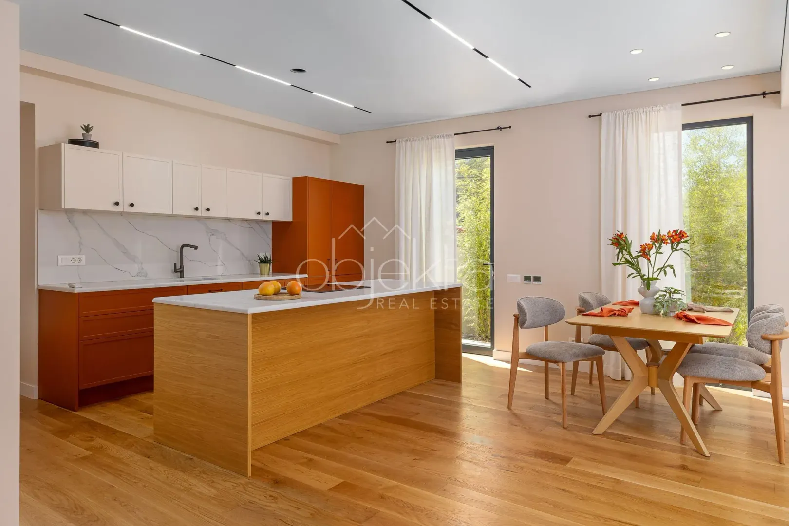 Modern kitchen with dining area, wooden elements, and a kitchen island.