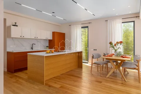 Modern kitchen with dining area, wooden elements, and a kitchen island. - image 5