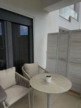 Furnished terrace with a table, chairs, and a screen divider. - image 3