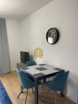 Living room with a dining table and blue chairs. - image 4