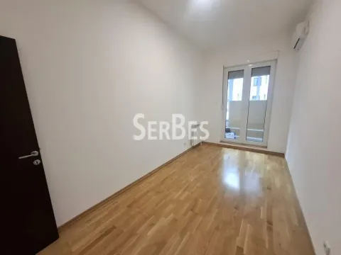Empty bright room with parquet flooring and balcony doors. - image 12