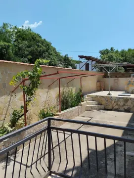 Dvorište kuće sa popločanim dijelom i ogradom. - image 7