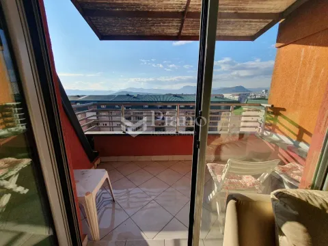 Covered balcony with a view of the city and mountains. - image 12