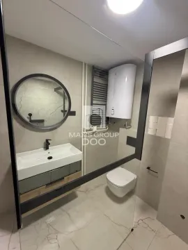 Modern bathroom equipped with a washbasin, mirror, and toilet bowl. - image 19