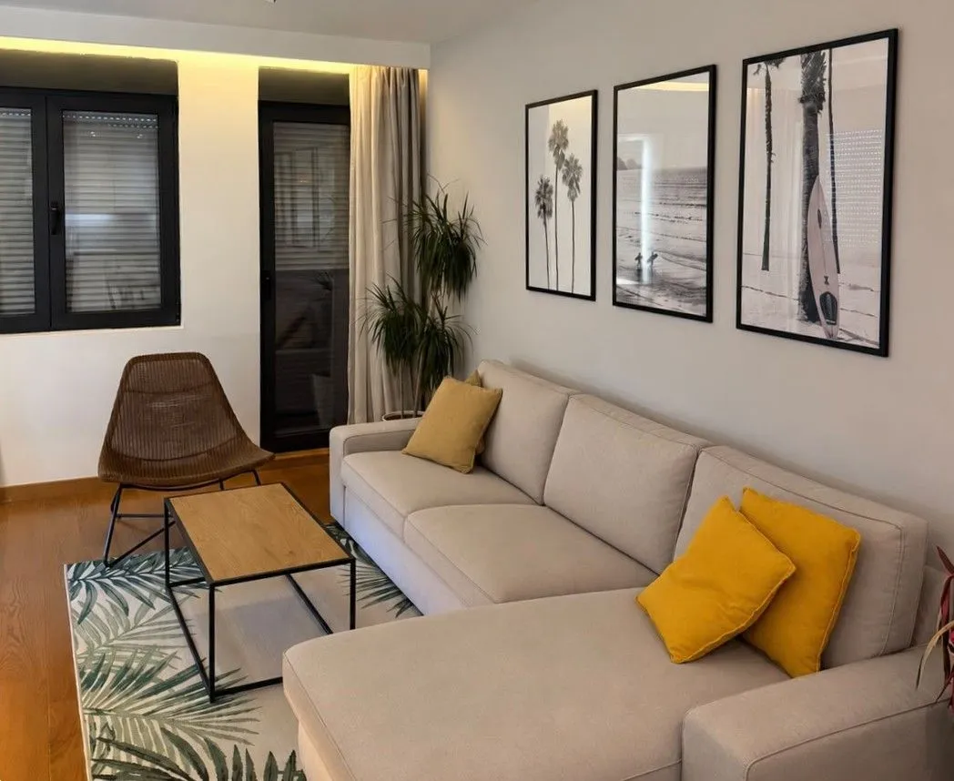 Modern living room with a sectional sofa and decorative wall art.