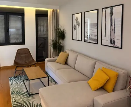 Modern living room with a sectional sofa and decorative wall art. - image 3