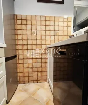 Smaller kitchen with cabinetry and ceramic wall tiles. - image 7