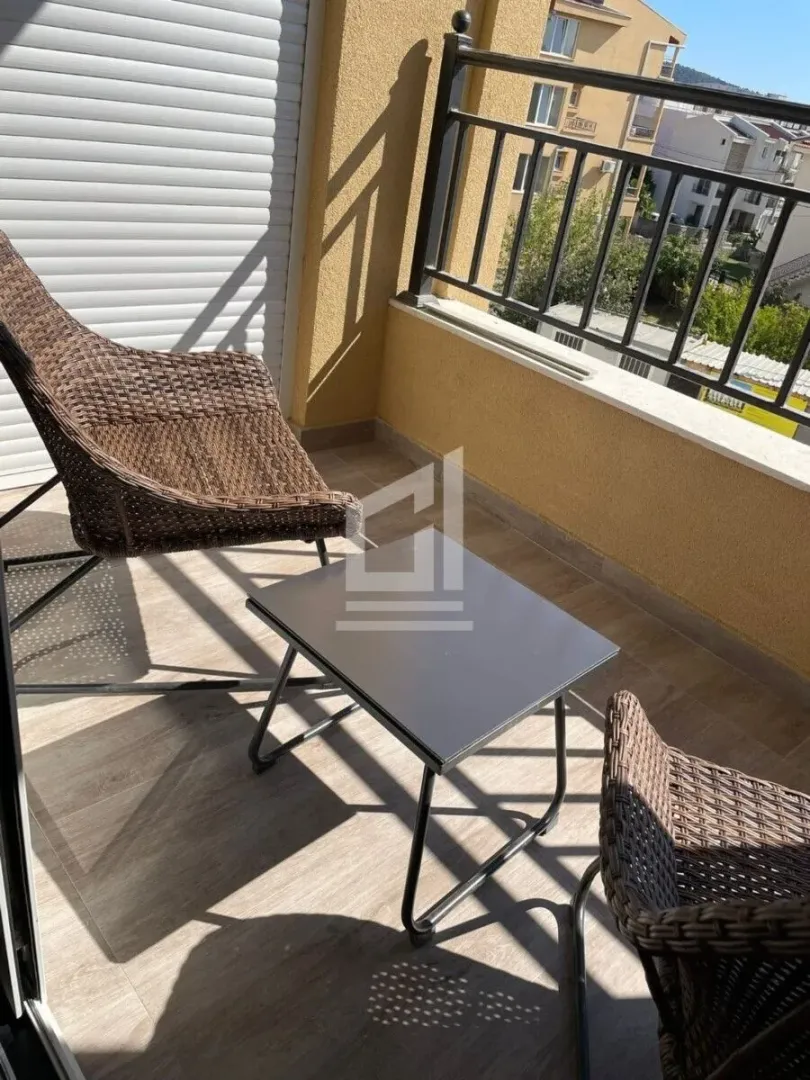 Furnished terrace with seating set and view of the surroundings.