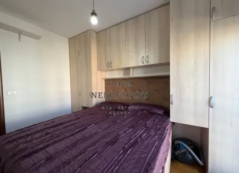 Bedroom with a double bed, built-in wardrobes, and wood-toned cabinetry. - image 8