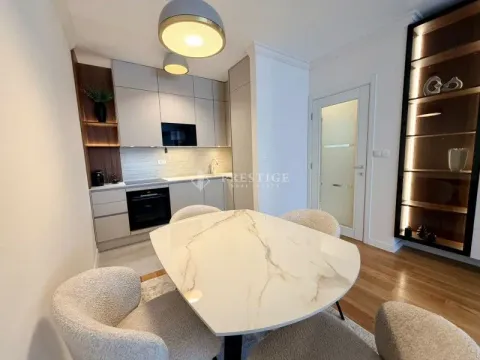 Modern kitchen with dining area and built-in appliances. - image 5