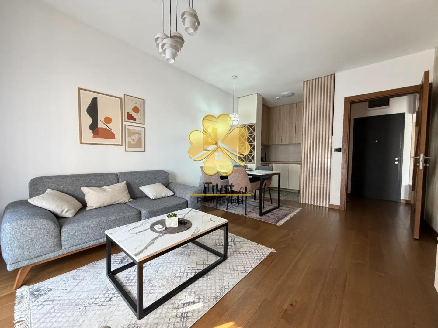 Modern living room connected to the dining area and kitchen.