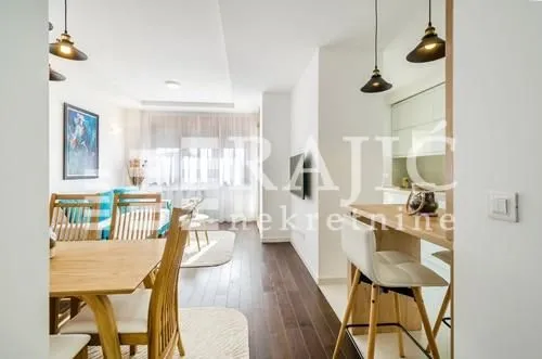 Bright living room with dining area and kitchen.