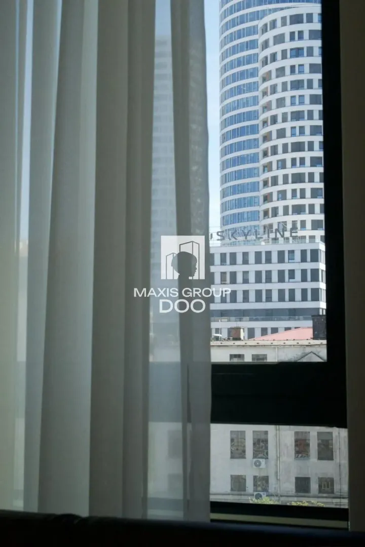 View through the window of surrounding buildings and cityscape.