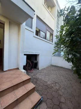 A paved patio area in front of the building entrance. - image 15