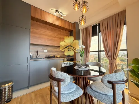 Modern kitchen with dining area and a large window. - image 5